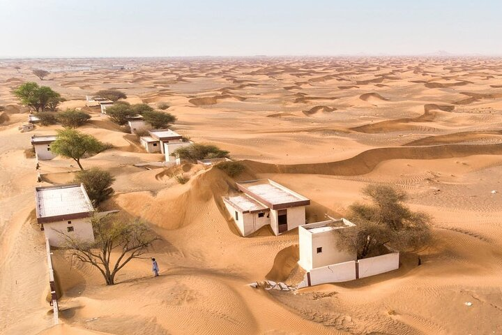 Explore the mysterious allure of an abandoned village where crumbling structures whisper stories of the past amidst endless sand dunes inviting travelers to uncover the secrets of its forgotten history.